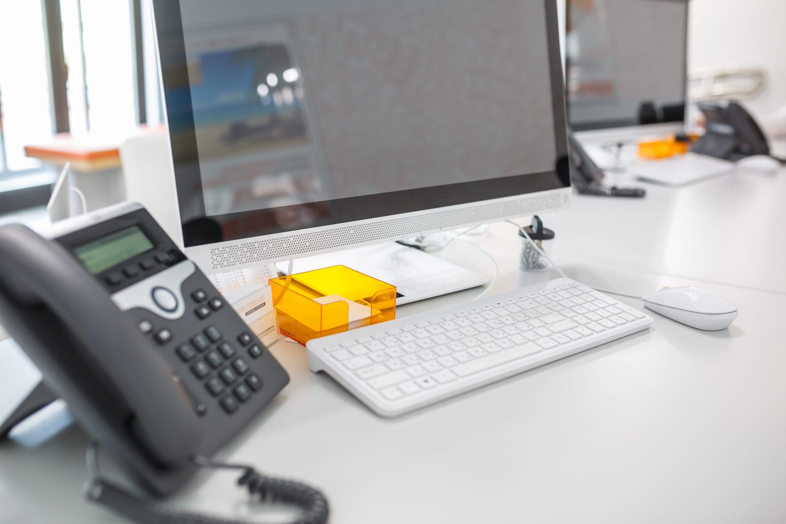 VoIP desk phone in a modern office